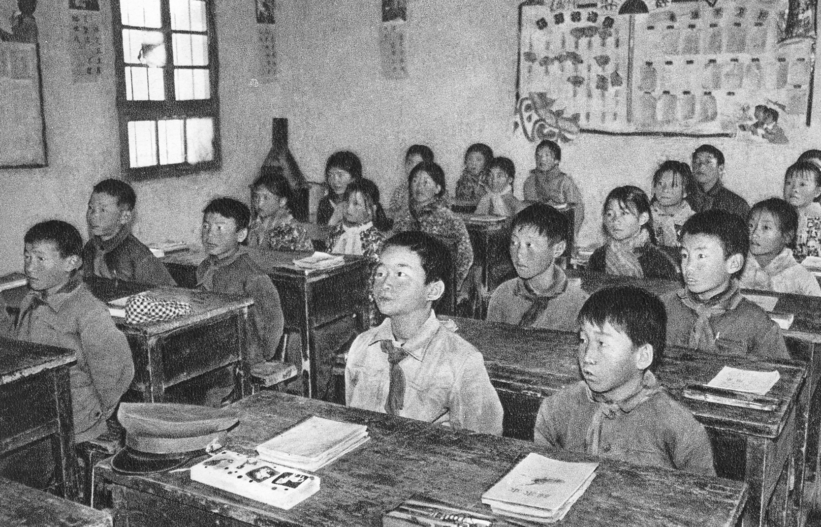 "还记得上小学一年级时课桌是用土块垒起来的,黑板也是用水泥抹在墙上